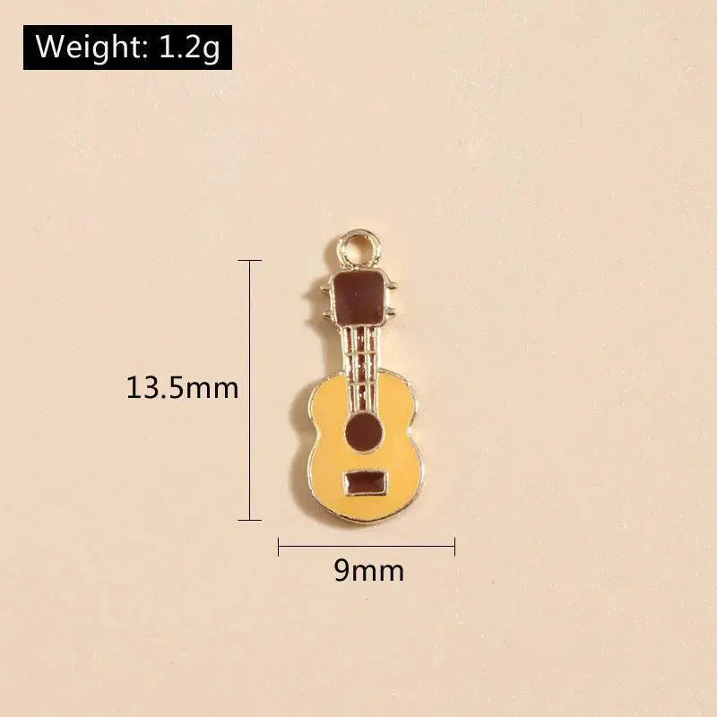 Small enamel guitar charm for DIY jewelry, 13.5mm x 9mm, shown on neutral background, OurLum