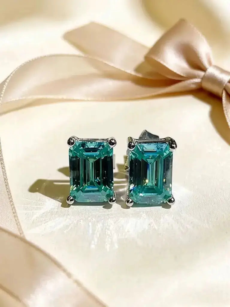 Green square moissanite stud earrings in a geometric setting