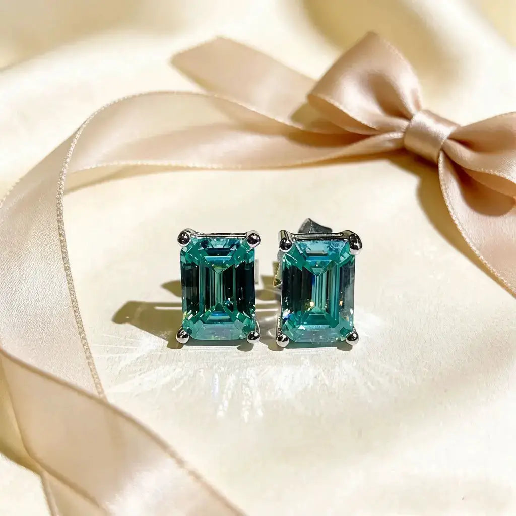 Green square moissanite stud earrings in a geometric setting