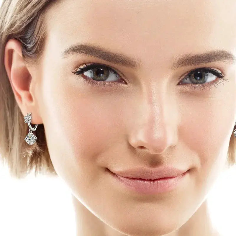 Woman wearing elegant silver and crystal drop earrings, beauty product at OurLum.com