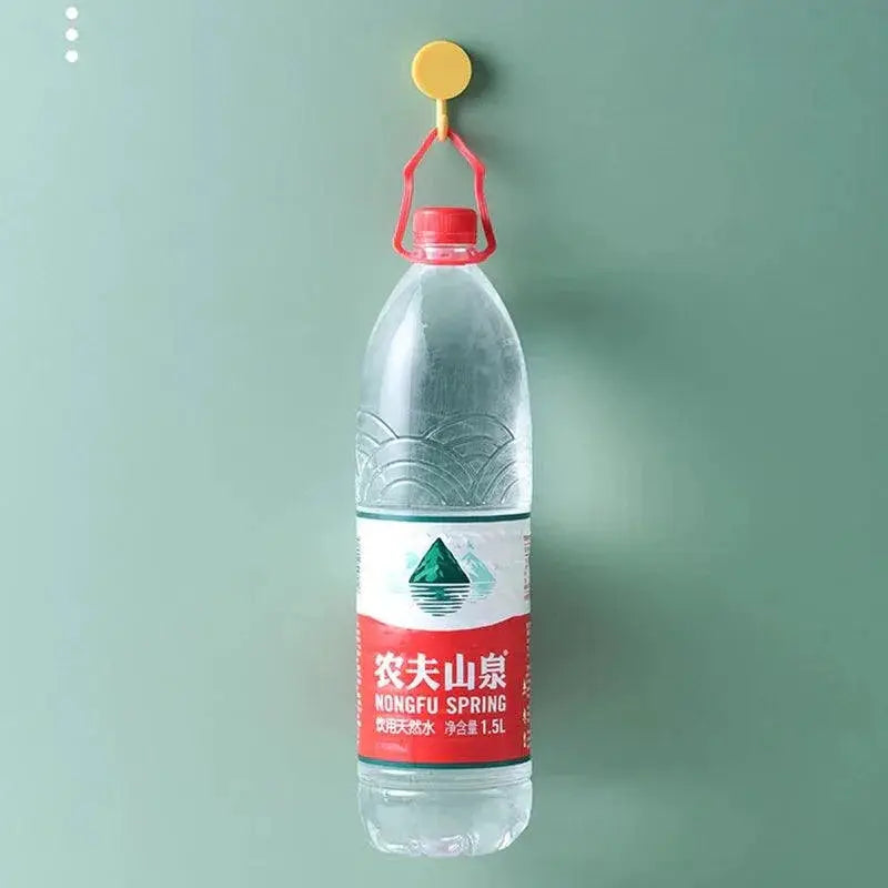 Adhesive decorative wall hook holding large water bottle on green wall, OurLum.com home solutions