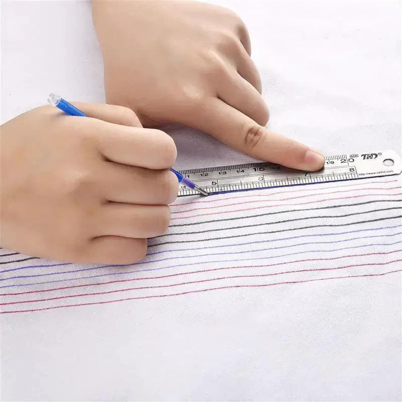Hand using heat erasable marker and ruler to draw fabric lines for sewing, OurLum.com DIY tools
