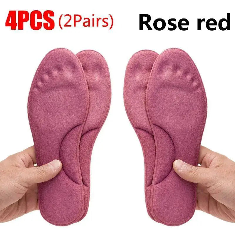 4 rose red self-heating memory foam insoles with arch support, held in hands
