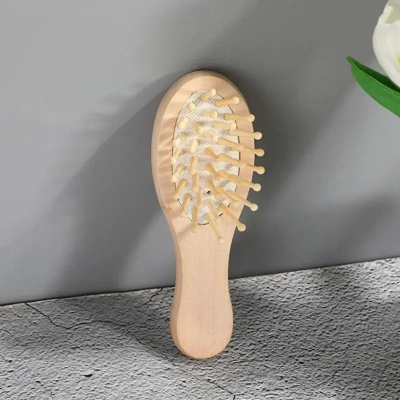 Natural bamboo hair comb with wide bristles for scalp massage on gray background