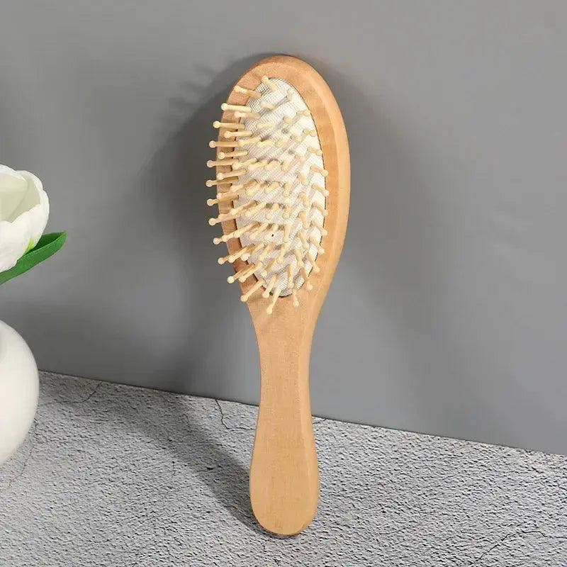 Bamboo hair comb with wooden bristles for scalp massage on gray background