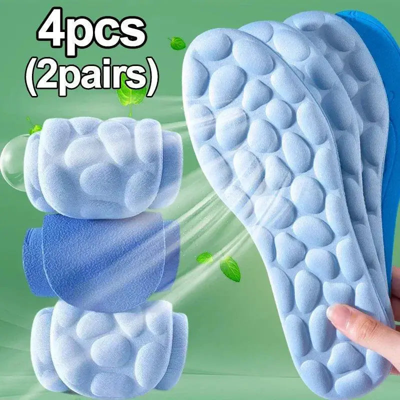 Blue memory foam sports insoles with acupressure texture, pack of 4, on green background.