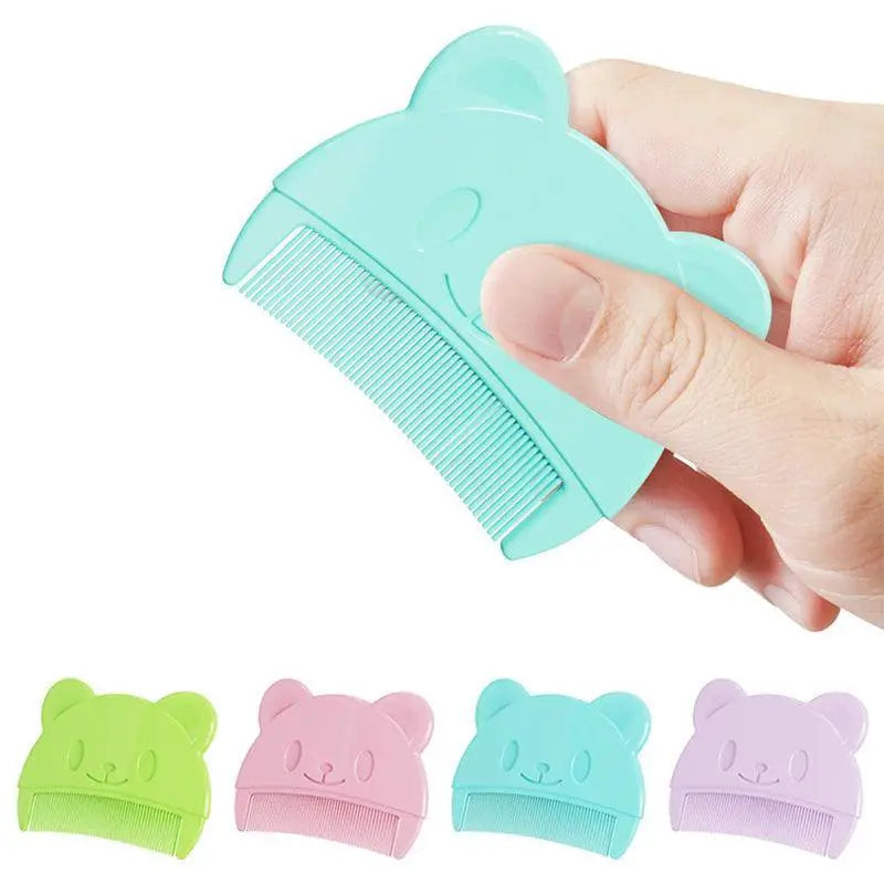 Hand holding a blue bear-shaped baby grooming comb, with similar combs in green, pink, blue, and purple.