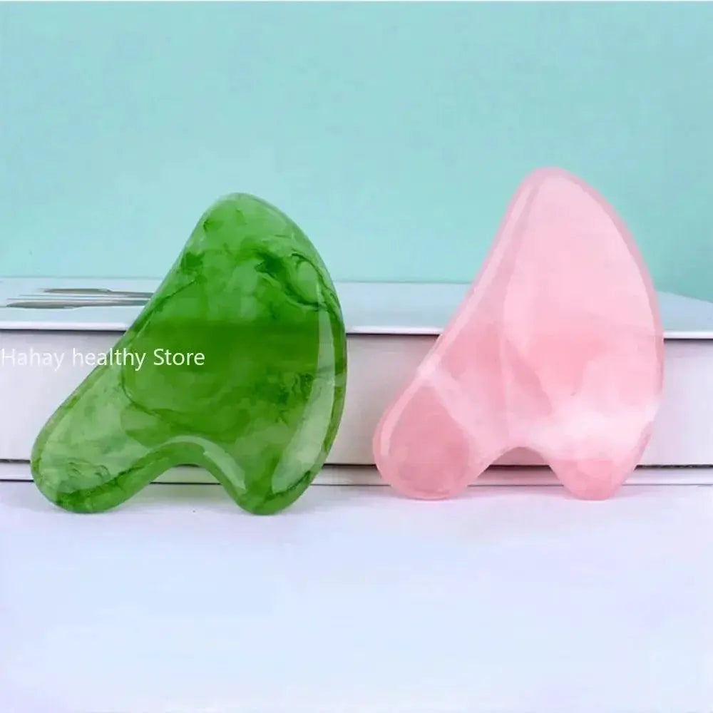 Green jade and pink rose quartz gua sha massage stones for facial skincare