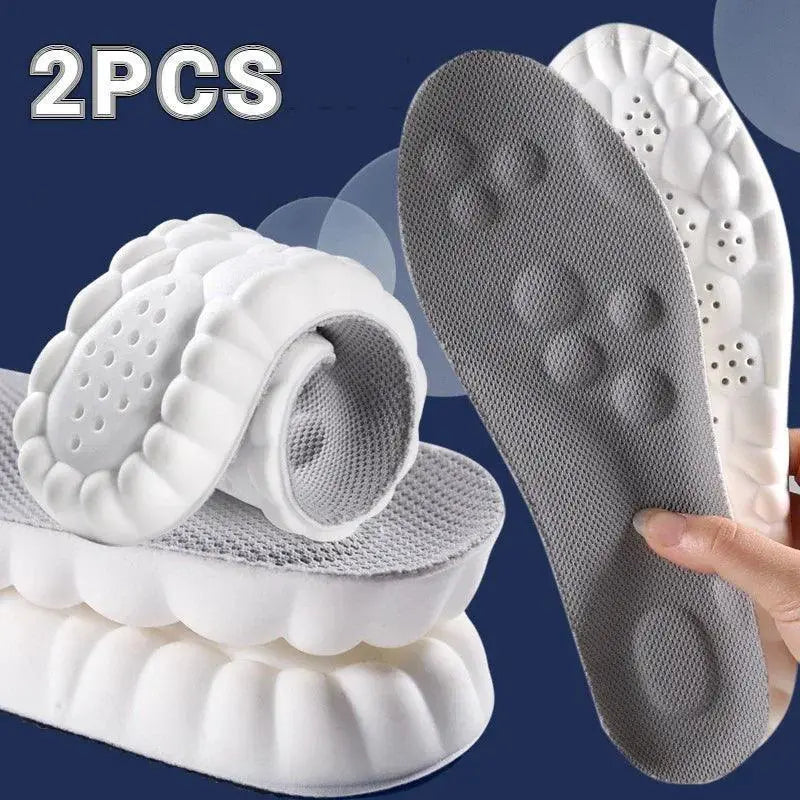 Pair of grey and white 4D massage insoles with ultimate arch support, flexible design