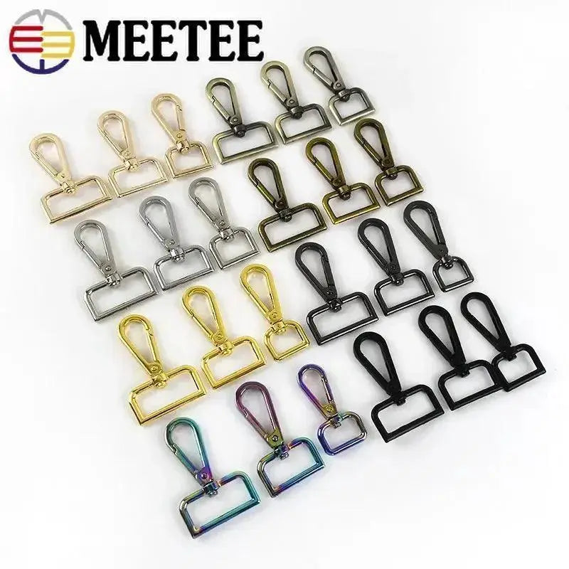 Assorted metal bag buckles, swivel snap hooks, and clasps in various finishes on white background.