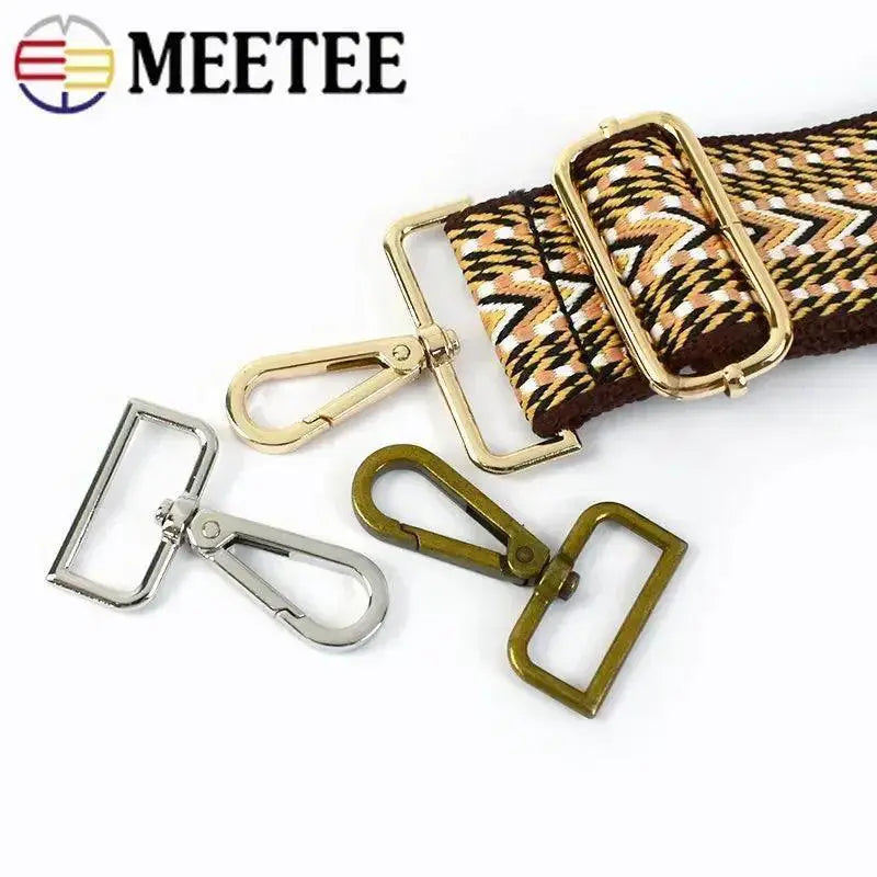 Assorted metal swivel snap hooks and rectangular buckles for bags, dog collars, or crafts on white background, with patterned strap—OurLum.com accessories.