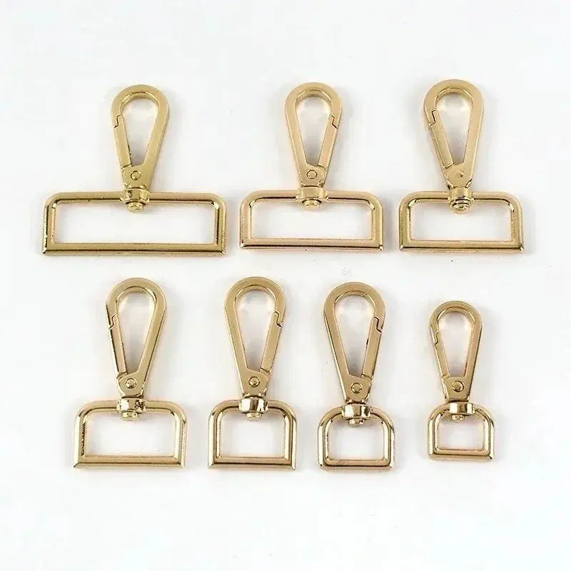 Gold metal swivel lobster clasps for bags, dog collars, and DIY crafts on white background