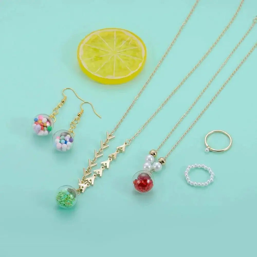 Colorful glass ball pendants, earrings, necklaces, and rings on mint background at OurLum.com