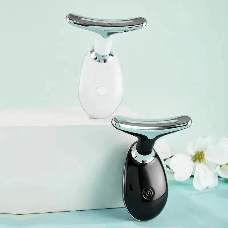 Two EMS face and neck beauty devices, black and white, with silver heads on a light background