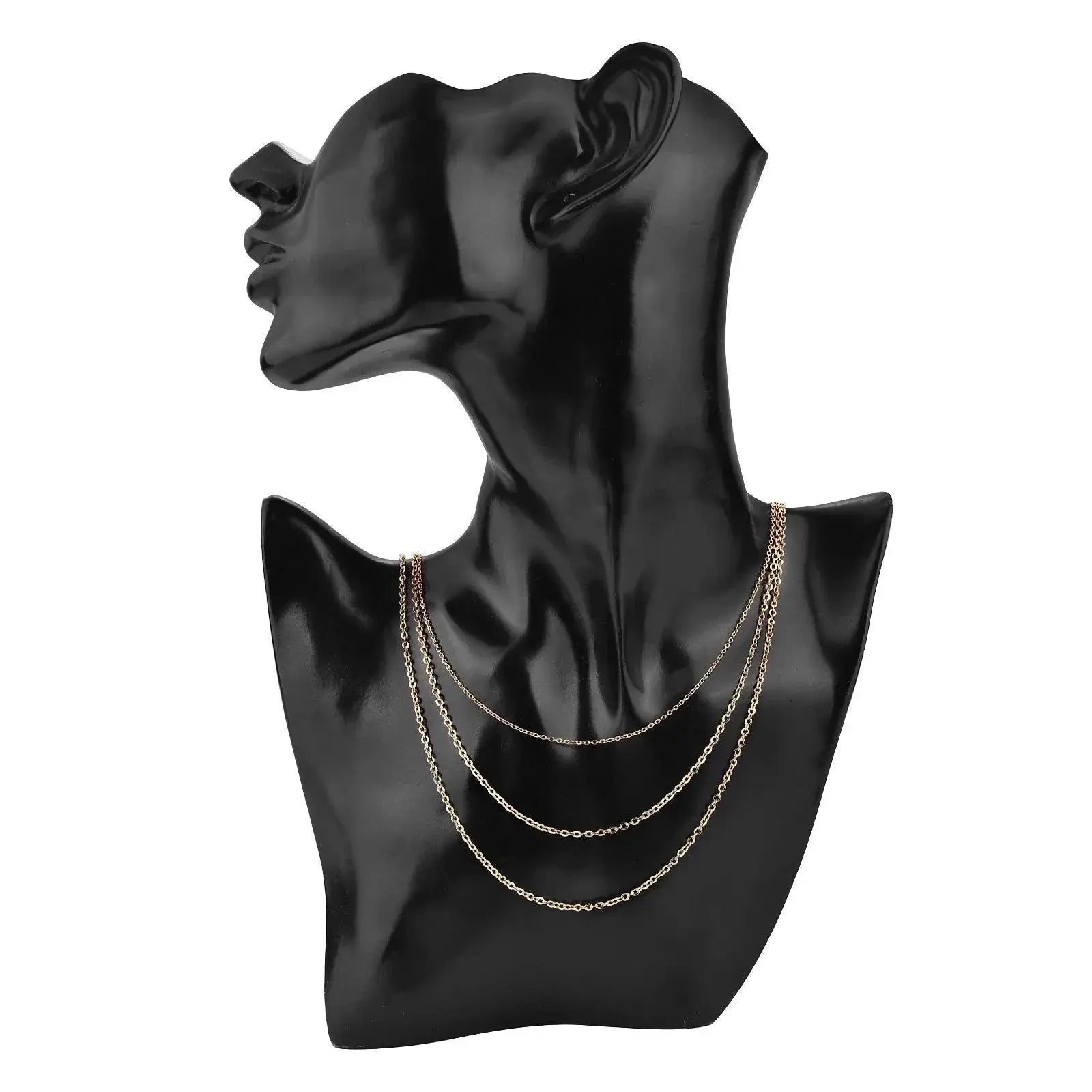 Gold stainless steel Cuban link necklace chains displayed on a black mannequin bust